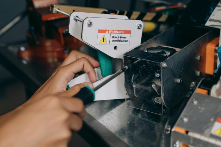 Close-up Shot of a Person Fixing the Metal Equipment Using Screw Driver